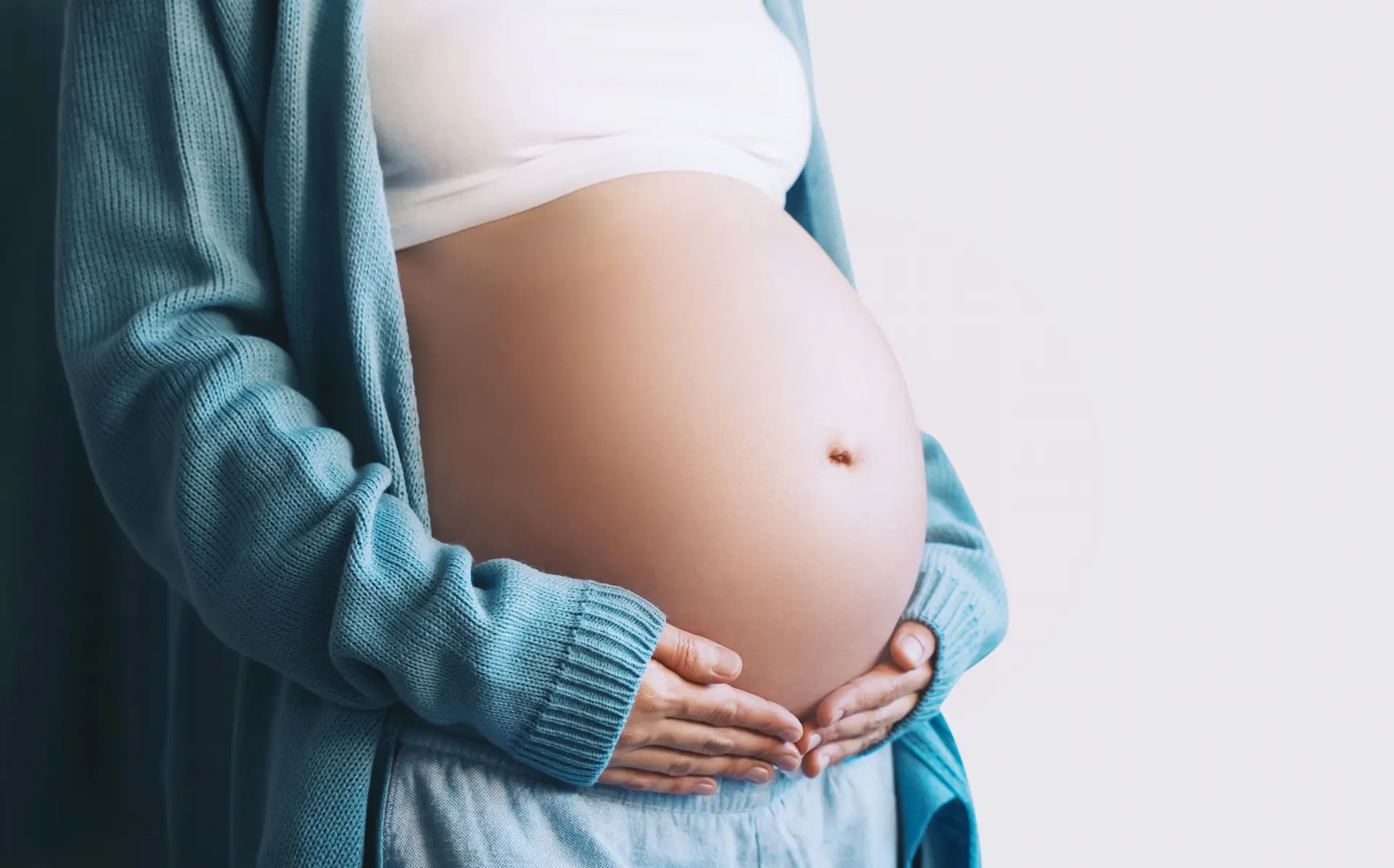 Mother holding her bump preparing for the transition to motherhood